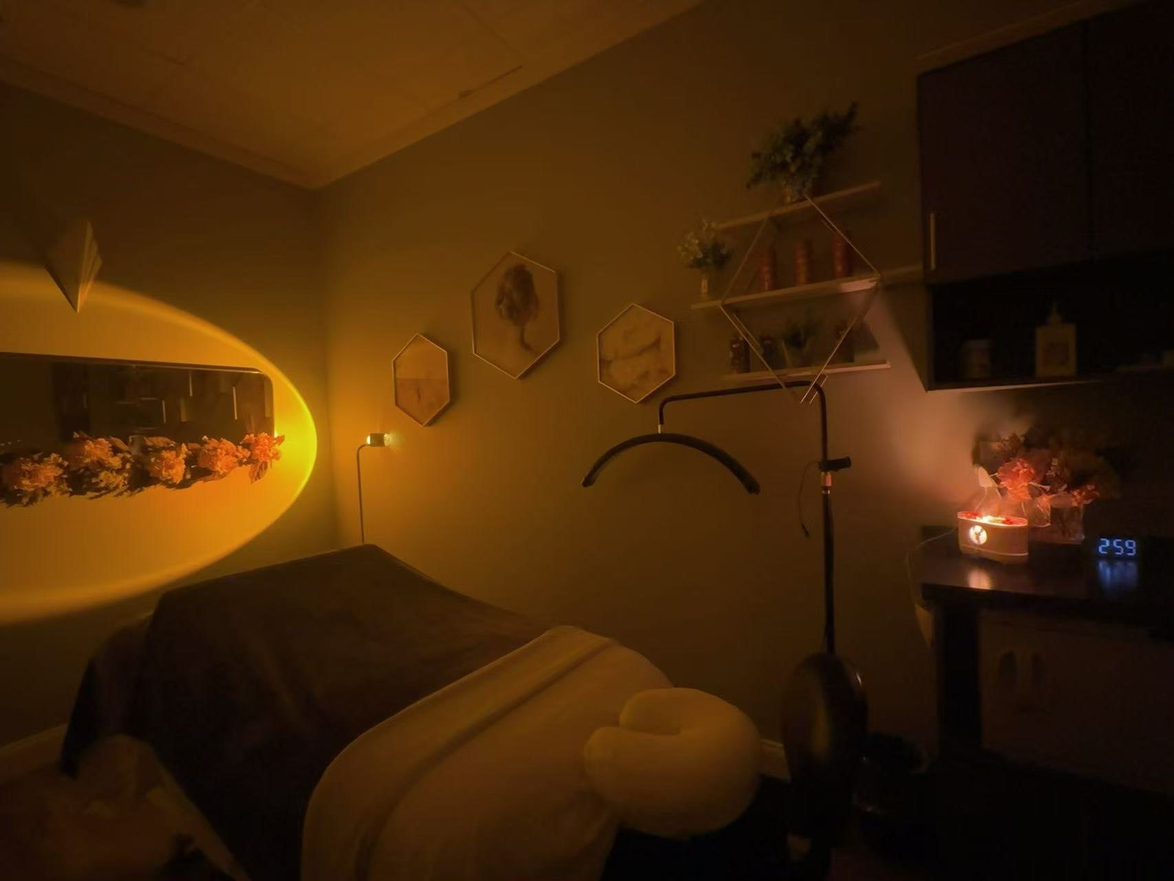 A Healing Hands Spa treatment room in Knoxville, TN: massage table with face cradle and warm lamp light